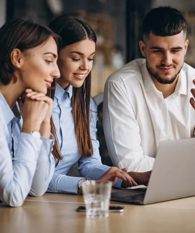 Business colleagues discussing cooperation around a laptop